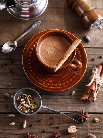Chai tea on a table with ingredients around it