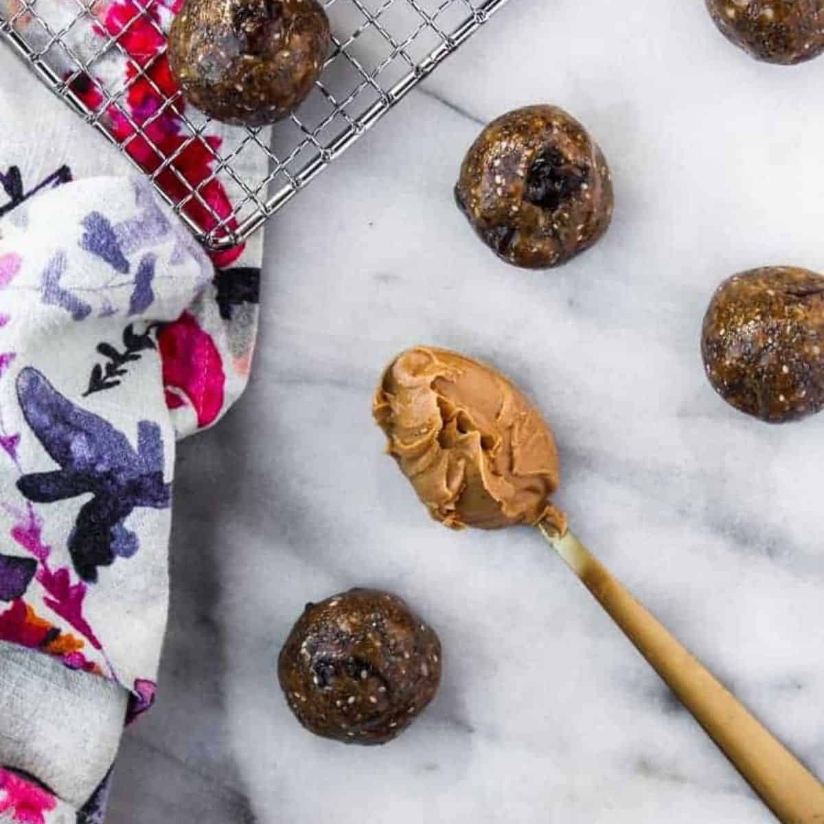 protein energy balls with a spoon of peanut butter in the middle 