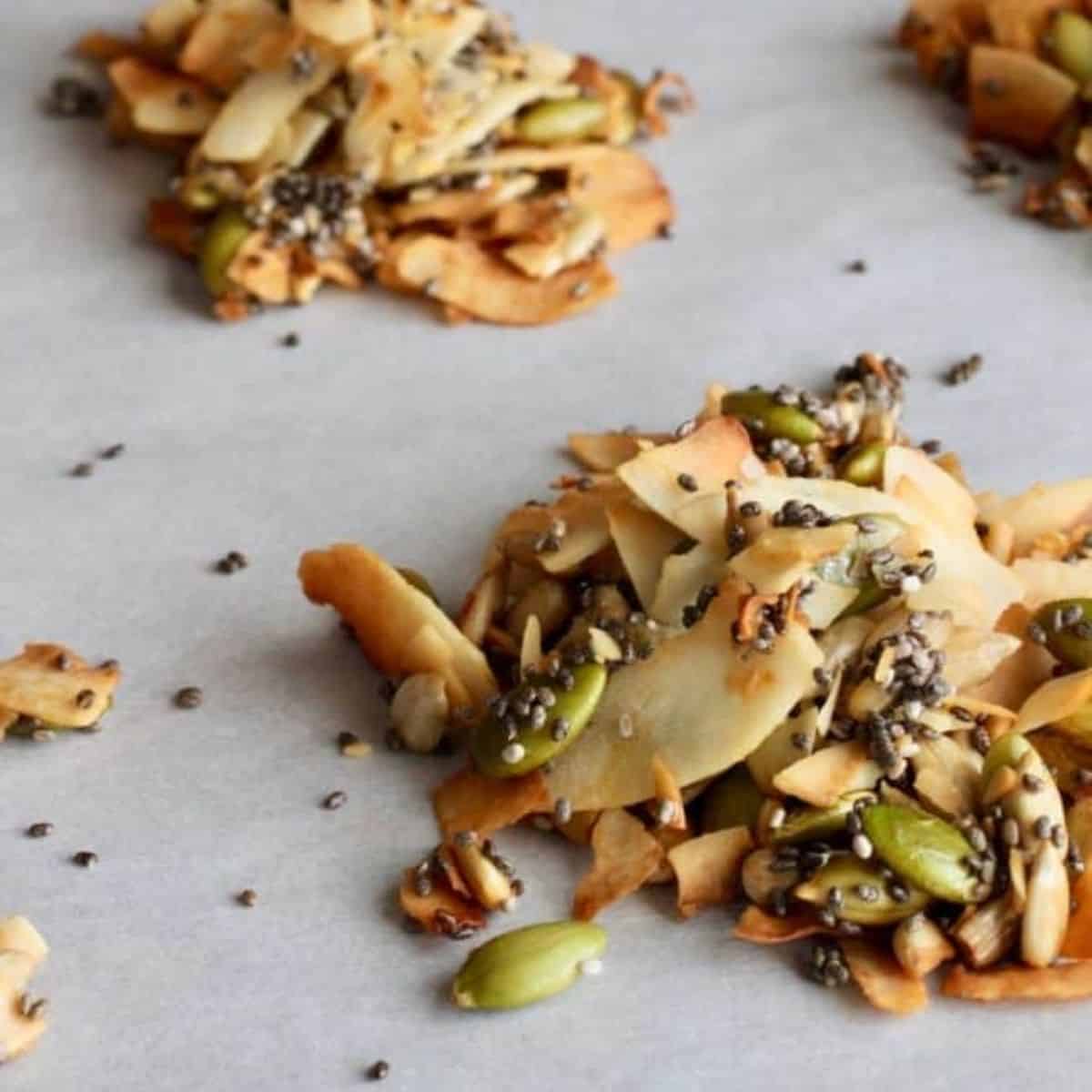 coconut clusters with pumpkin seeds, toasted coconut, on a baking pan