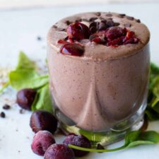Chocolate Cherry smoothie in a short glass garniished with cherries and chocolate chips