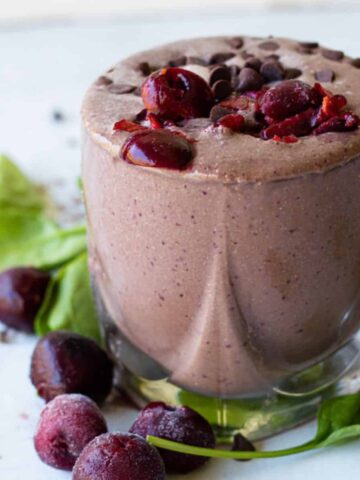 Chocolate Cherry smoothie in a short glass garniished with cherries and chocolate chips