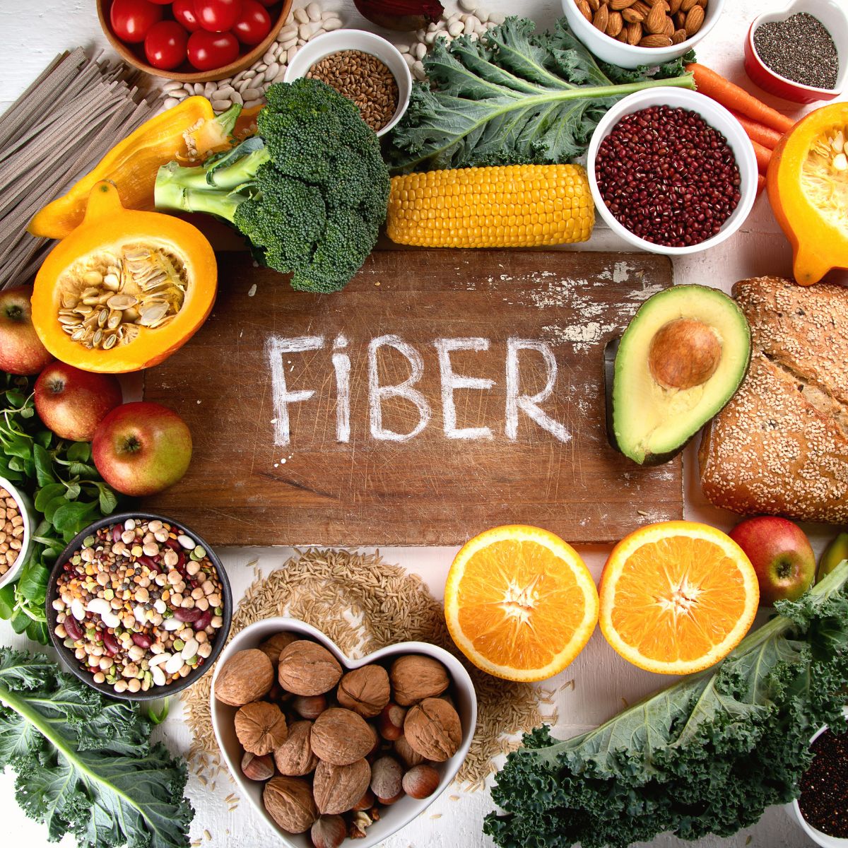 FIber written on a chalkboard, surrounded by high fiber foods. 