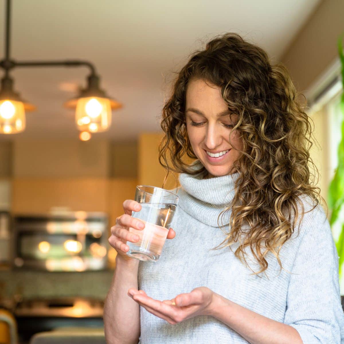 Woman taking probiotics and prebiotics together. 