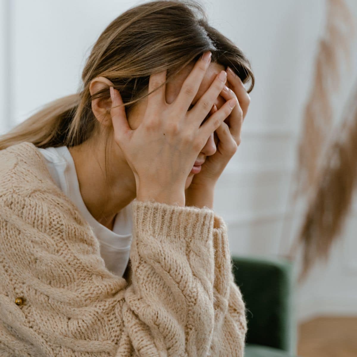 woman stressed and obsessing about food with her head in her hands