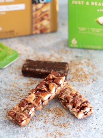 image of kind bars and lara bars - two high fiber food bars on a table with their boxes in the background