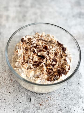 bowl of cinnamon roll overnight oats with a cinnamon swirl