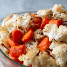 up close image of roasted carrots and cauliflower in a bowl