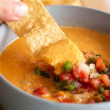 Cottage Cheese Queso topped with pico de gallo as a dip for tortilla chips