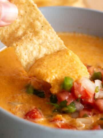 Cottage Cheese Queso topped with pico de gallo as a dip for tortilla chips