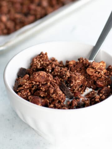 bowl of dark chocolate granola with oats and chocolate chunks, nutritious breakfast or snack