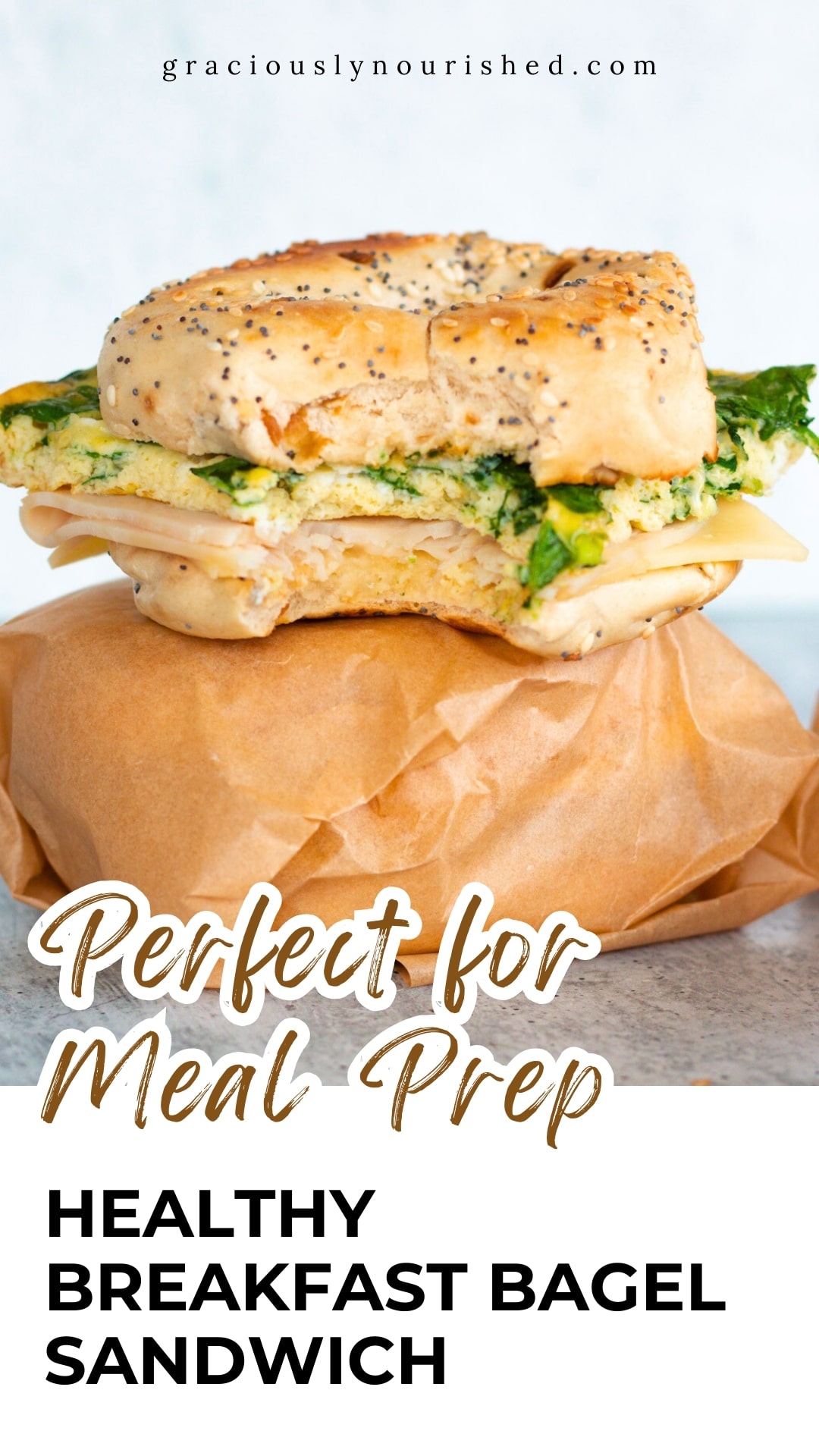 Healthy breakfast bagel sandwich with eggs, spinach, turkey, and melty cheese perfect for meal prep.