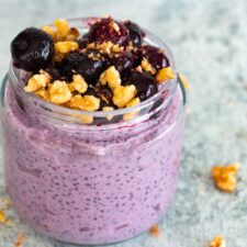 Blueberry chia seed pudding in a glass jar, a creamy, make-ahead snack made with blueberries, chia seeds, milk, and Greek yogurt.