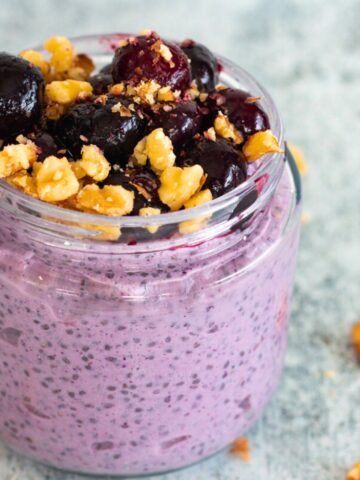 Blueberry chia seed pudding in a glass jar, a creamy, make-ahead snack made with blueberries, chia seeds, milk, and Greek yogurt.