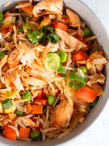 A quick and easy salmon fried rice packed with tender salmon, fluffy rice, and savory seasonings, ready in just 15 minutes for a flavorful and fuss free meal.