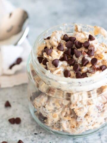 Cookie dough overnight oats in a jar, thick, doughy, and topped with chocolate chips for a high-fiber, high-protein breakfast.