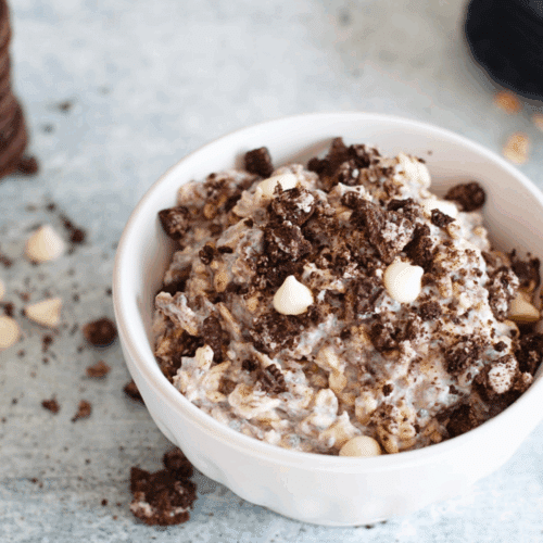 Cookies and cream overnight oats in a jar, thick and creamy with crushed cookie pieces for an easy, high-protein breakfast.