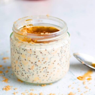 A jar of maple and brown sugar overnight oats topped with maple syrup.