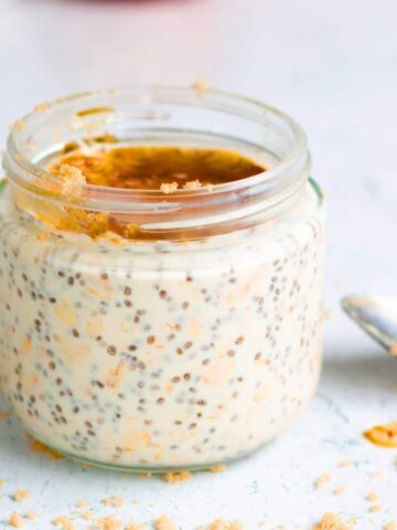 A jar of maple and brown sugar overnight oats topped with maple syrup.