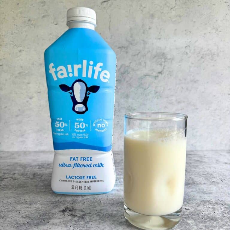 Fairlife ultra-filtered milk bottle beside a glass filled with milk. Is ultra-filtered milk healthy?