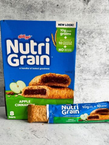 A box of Nutrigrain bars with one bar placed on a table. Are nutrigrain bars healthy