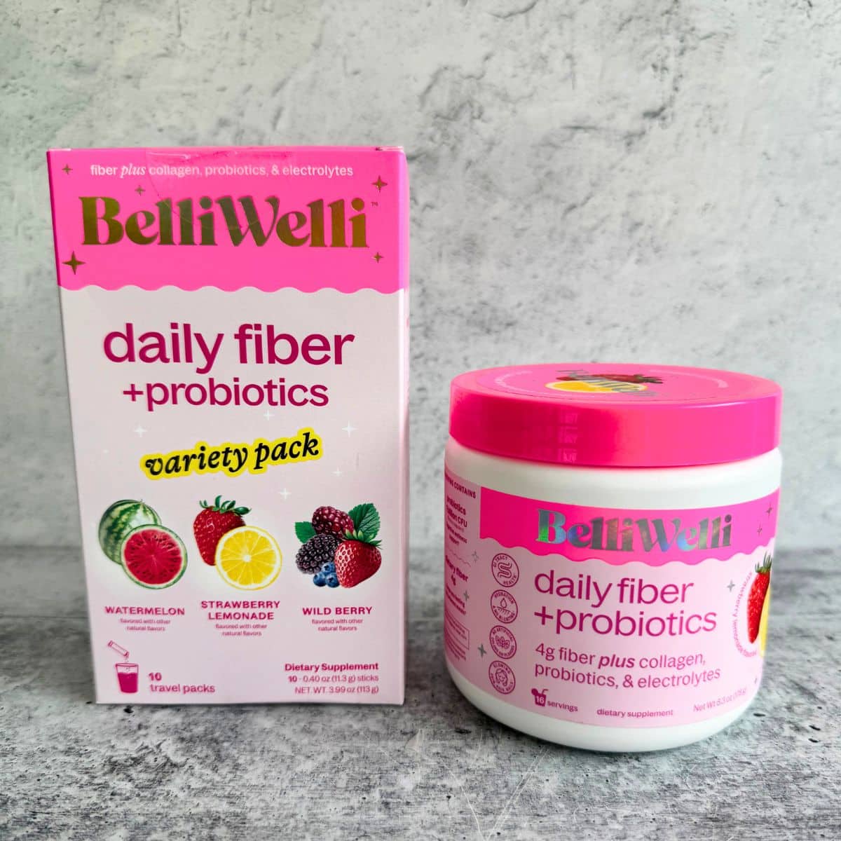 A box of Belliwelli Strawberry Lemonade Daily Fiber Supplement packs with a 6.3oz powder container placed on a table. Belliwelli review.