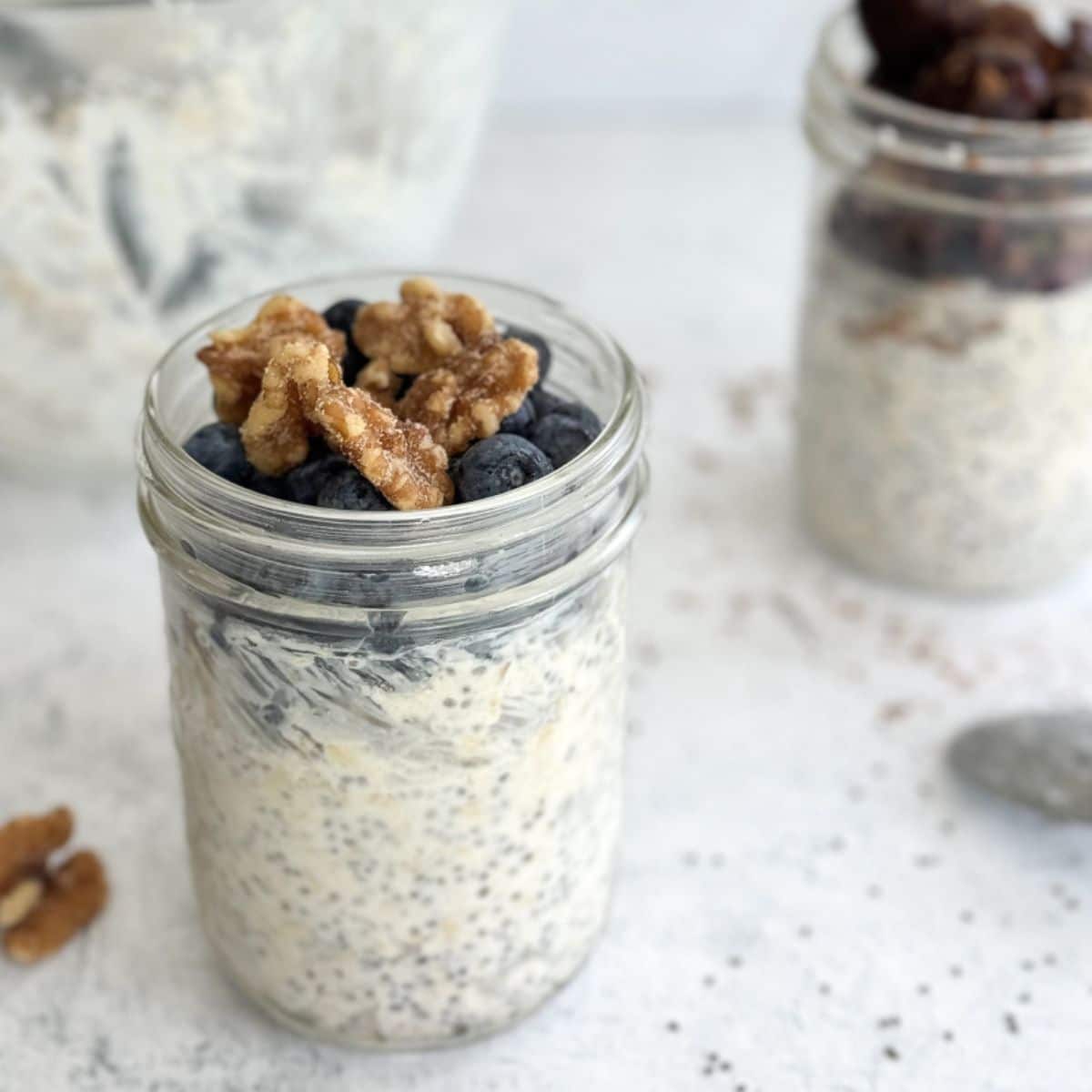 A jar of overnight oats with blueberries and walnuts.